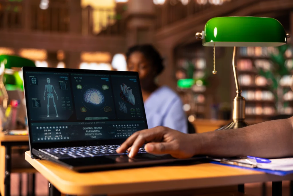 Research about education with a researcher analyzing scientific medical data on a laptop
